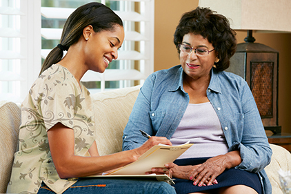 image of community health liaison helping a client find services to connect her to  support of her ongoing care